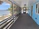 Long screened-in balcony features beach view with palm trees, offering a tranquil outdoor space at 3461 Gum Dr, Weeki Wachee, FL 34607