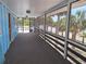 Spacious screened-in balcony with a beautiful view of tropical palm trees and the beach at 3461 Gum Dr, Weeki Wachee, FL 34607