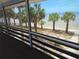 Scenic view from the screened-in balcony, showcasing tropical palm trees and tranquil beachfront access at 3461 Gum Dr, Weeki Wachee, FL 34607