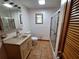Bathroom with shower, toilet, sink, vanity and tile flooring at 3461 Gum Dr, Weeki Wachee, FL 34607