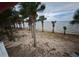 Palm trees line the sandy beachfront, offering serene views of the waterfront at 3461 Gum Dr, Weeki Wachee, FL 34607