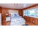 Charming bedroom with wood paneled walls, matching nautical decor, and natural light at 3461 Gum Dr, Weeki Wachee, FL 34607