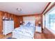 Charming bedroom with wood paneled walls, nautical decor, and white dressers at 3461 Gum Dr, Weeki Wachee, FL 34607