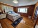 Comfortable bedroom with hardwood floors, large window, and nautical-themed accents at 3461 Gum Dr, Weeki Wachee, FL 34607