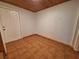 Tiled entryway with white door, wood-paneled walls, and a wood ceiling at 3461 Gum Dr, Weeki Wachee, FL 34607