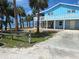 Charming blue two-story waterfront home surrounded by palm trees at 3461 Gum Dr, Weeki Wachee, FL 34607