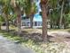 Coastal home's pathway and surrounding greenery create a serene setting for relaxation and enjoyment of beachside living at 3461 Gum Dr, Weeki Wachee, FL 34607