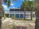 Lovely two-story beach house with white railing and a spacious lower level perfect for relaxation and entertaining at 3461 Gum Dr, Weeki Wachee, FL 34607