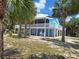 Charming elevated beach house with a spacious wrap-around porch, perfect for enjoying the coastal breeze at 3461 Gum Dr, Weeki Wachee, FL 34607
