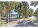 Exterior of a blue two-story home with palm trees at 3461 Gum Dr, Weeki Wachee, FL 34607