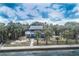 Aerial view of a charming coastal home nestled among swaying palm trees near the water at 3461 Gum Dr, Weeki Wachee, FL 34607