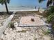 An outdoor brick fire pit near the water, provides a cozy space for enjoying evenings by the waterfront at 3461 Gum Dr, Weeki Wachee, FL 34607