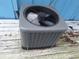 An outdoor HVAC unit sits on a wooden platform, providing efficient climate control for comfortable living at 3461 Gum Dr, Weeki Wachee, FL 34607
