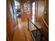 Hallway with wood paneling and floors leading to various rooms at 3461 Gum Dr, Weeki Wachee, FL 34607