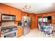 Eat-in kitchen features stainless appliances, wooden cabinets, and adjacent breakfast nook at 3461 Gum Dr, Weeki Wachee, FL 34607
