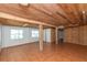 Bright living area featuring tile floors, natural light, wooden support beams, and wood paneling at 3461 Gum Dr, Weeki Wachee, FL 34607