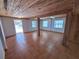 Spacious living room features tile flooring, exposed wood ceiling, and views of the outdoors at 3461 Gum Dr, Weeki Wachee, FL 34607