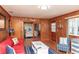 Living room with view into bedroom, nautical decor and wooden paneling at 3461 Gum Dr, Weeki Wachee, FL 34607