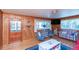 Nautical themed living room features wooden paneling, comfortable seating and water views at 3461 Gum Dr, Weeki Wachee, FL 34607