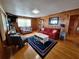 Cozy living room features wood paneling, nautical decor, and comfortable seating at 3461 Gum Dr, Weeki Wachee, FL 34607