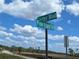 Street signs showing Cortez Blvd and Pine Island Dr under a blue, partly cloudy sky at 3461 Gum Dr, Weeki Wachee, FL 34607
