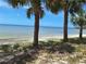 Waterfront view featuring calm water, clear blue sky, and mature palm trees at 3461 Gum Dr, Weeki Wachee, FL 34607