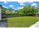 Spacious backyard features a lush lawn, mature trees, and a privacy fence at 4035 Fairfield S Ave, St Petersburg, FL 33711