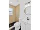 Updated bathroom features modern fixtures, black tile floors, and a bright window at 4035 Fairfield S Ave, St Petersburg, FL 33711