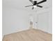 Room featuring wood-look floors and bright neutral walls, open closet and modern ceiling fan at 4035 Fairfield S Ave, St Petersburg, FL 33711