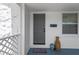Charming front porch with gray door, welcome mat, decorative vases, and a window at 4035 Fairfield S Ave, St Petersburg, FL 33711