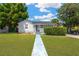 Charming single-story home featuring a well-manicured lawn and inviting walkway at 4035 Fairfield S Ave, St Petersburg, FL 33711