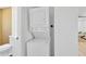 Convenient laundry area with stacked washer and dryer unit and access to the bathroom at 4035 Fairfield S Ave, St Petersburg, FL 33711