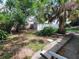 Picturesque backyard with mature trees, a storage shed, and a private setting at 4118 Flamingo Dr, New Port Richey, FL 34652