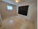 Bedroom with tan walls, a window, ceiling fan, and terrazzo flooring at 4118 Flamingo Dr, New Port Richey, FL 34652