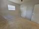 Bedroom with terrazzo floors, closet, neutral paint and bright window at 4118 Flamingo Dr, New Port Richey, FL 34652