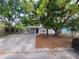 Charming single-story home with mature trees and covered parking, creating a welcoming curb appeal at 4118 Flamingo Dr, New Port Richey, FL 34652