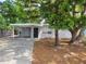 Well-maintained single-story home with covered parking and mature landscaping at 4118 Flamingo Dr, New Port Richey, FL 34652