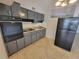 Kitchen featuring gray cabinets, black appliances, and neutral countertops at 4118 Flamingo Dr, New Port Richey, FL 34652