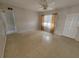Bright living room featuring terrazzo flooring, a ceiling fan, and lots of natural light at 4118 Flamingo Dr, New Port Richey, FL 34652