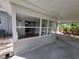 Cozy enclosed patio with large windows and access to the yard, ideal for year-round enjoyment at 4118 Flamingo Dr, New Port Richey, FL 34652