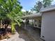 A covered patio with access to a fenced yard, offering a great outdoor living space at 4118 Flamingo Dr, New Port Richey, FL 34652