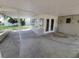 Covered patio area with access to the backyard and an enclosed sunroom, perfect for outdoor gatherings at 4118 Flamingo Dr, New Port Richey, FL 34652
