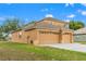 Charming two-story home featuring a large three-car garage, well-maintained lawn, and attractive neutral paint at 4335 Canongate Ct, Spring Hill, FL 34609