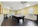 Well-lit game room with pool table, wainscoting, and arched windows at 4335 Canongate Ct, Spring Hill, FL 34609