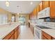 Modern kitchen includes white appliances, tile backsplash, stylish pendant lights, and outdoor views at 4335 Canongate Ct, Spring Hill, FL 34609