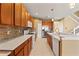Gourmet kitchen features wood cabinets, stainless steel appliances, tile backsplash, and modern countertops at 4335 Canongate Ct, Spring Hill, FL 34609