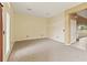 Neutral living room featuring walls, carpeted flooring, light fixtures, and a door to the yard at 4335 Canongate Ct, Spring Hill, FL 34609