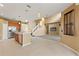 Bright kitchen with stainless steel appliances, pendant lights, and a view into the carpeted living room with stairs at 4335 Canongate Ct, Spring Hill, FL 34609