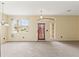 Spacious living room with neutral paint, carpeted flooring, light fixtures, and large windows at 4335 Canongate Ct, Spring Hill, FL 34609