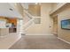 Bright living room featuring a staircase and seamless flow into the modern kitchen at 4335 Canongate Ct, Spring Hill, FL 34609